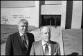 Photograph: [Two Men Standing in Front of New Health Center]