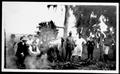Photograph: [Group of men near an underground barbecue pit at Camp George]