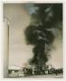 Primary view of [Cloud of Black Smoke Rising from Metal Building]