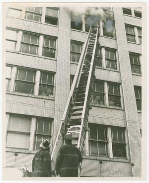 Primary view of [Firefighters Look Up at a Smoking Window]