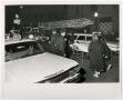 Photograph: [Officers and Injured Man on Gurney in a Street]