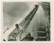 Photograph: [Firefighters Hose Down an Unfinished Building]