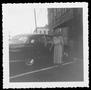 Photograph: [Photograph of Mamie Davis George standing next to a black automobile]
