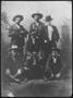 Photograph: [Photograph of six men with a dog]