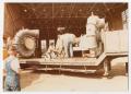 Photograph: [Workers dismantling an old diesel generator - close-up]