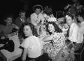 Photograph: [Party Goers Sitting at a Table]