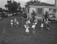 Photograph: [Children Walking Around Maypole at a Boy's Birthday Party]
