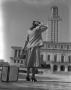 Photograph: [Woman Standing Outside the University of Texas Clock Tower]