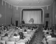 Photograph: [Two Men Standing in Front of a Theater of People]