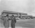 Photograph: [Two Men Outside a Austin Industries Building]