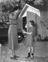 Photograph: [Brownie Girl Scout Saluting]