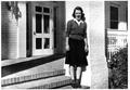 Photograph: [Mary Jones on the front steps of the Pi Beta Phi Sorority House]