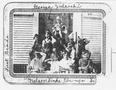 Photograph: [Photograph of nine first grade students sitting/standing on the step…