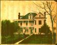 Photograph: [J.H.P. Davis in front of Davis house, standing on the shrub lined si…