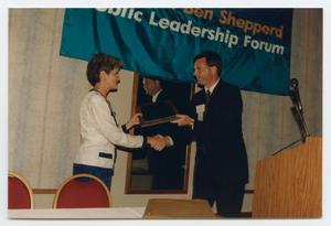 Primary view of object titled '[Photograph of Cassandra Carr Receiving Plaque]'.