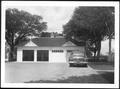 Photograph: [A car parked in front of George Ranch house garage]