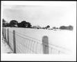 Photograph: [Fence next to the snow covered George Ranch house and yard]