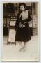 Primary view of [Postcard Picturing a Woman on a Sidewalk, 1939]