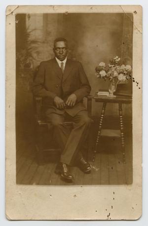 Primary view of object titled '[Postcard Picturing a Seated African-American Man]'.