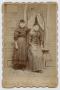 Primary view of [Photograph of Daisy and Katie Pennington in Front of a Window]