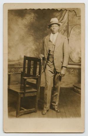 Primary view of object titled '[Postcard Picturing an African-American Man Next to a Chair]'.