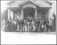 Photograph: [Students standing and kneeling in front of the George School]