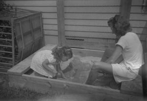 Primary view of object titled '[Woman and Child in Sandbox]'.