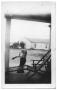 Primary view of [Man walking by porch]