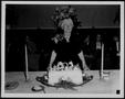 Photograph: [Babe Leake standing behind a cake at her 90th birthday party]