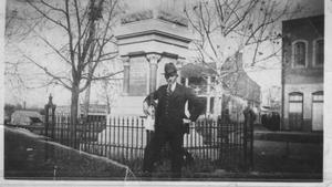 Primary view of object titled '[A man standing in front of the Jaybird Monument]'.
